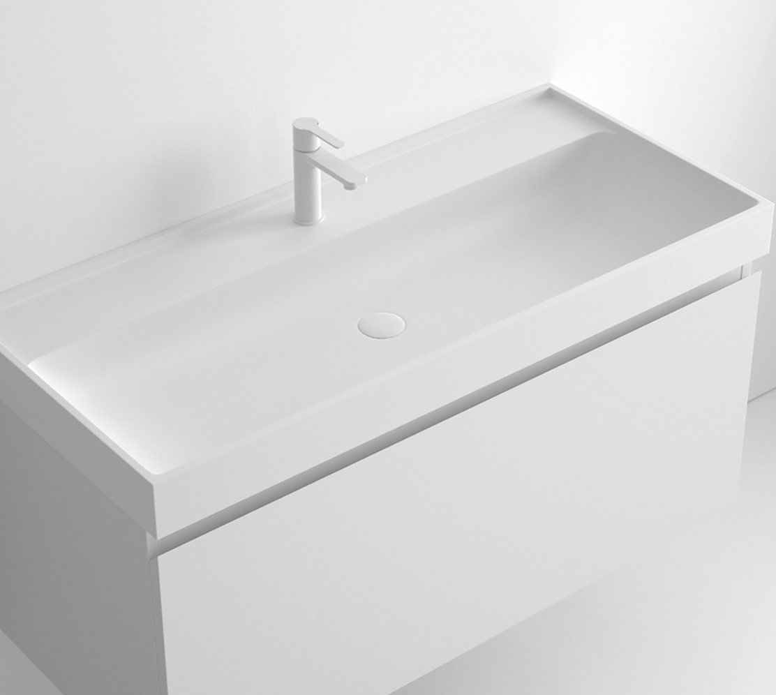 Encimera con faldón Tribeca de Stoneacril® con lavabo integrado de Madero Atelier para mueble Tribeca